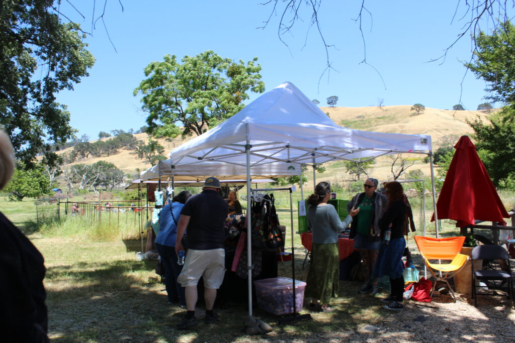 Shoppers at tent of vendor