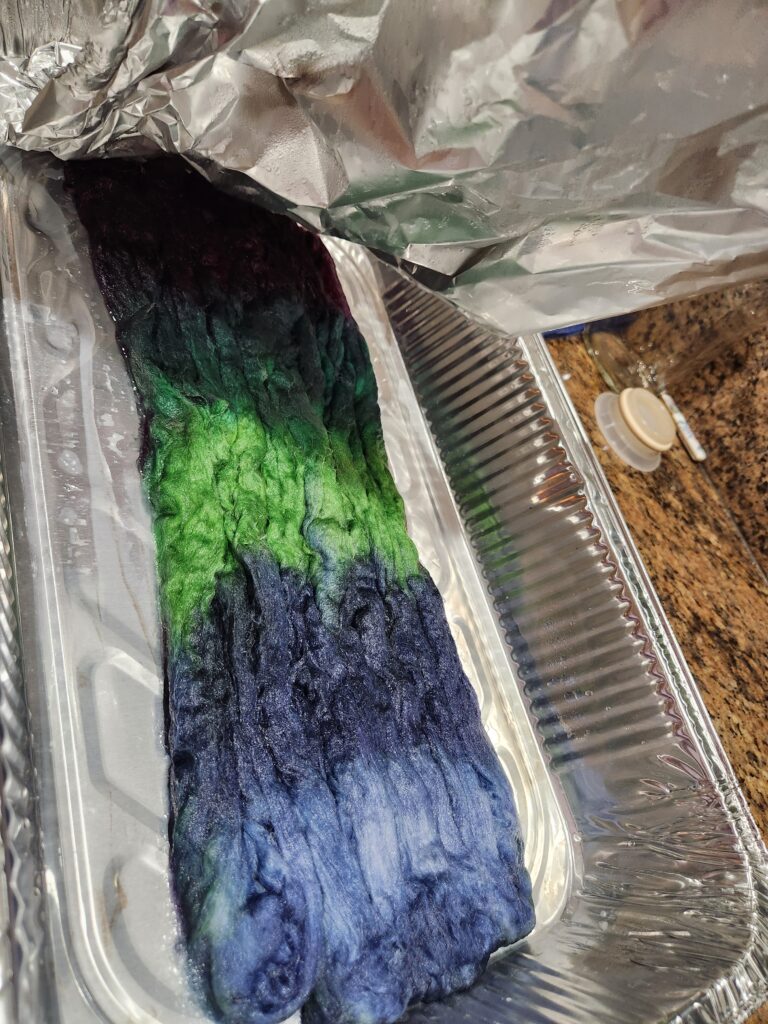 Freshly dyed roving in aluminum pan