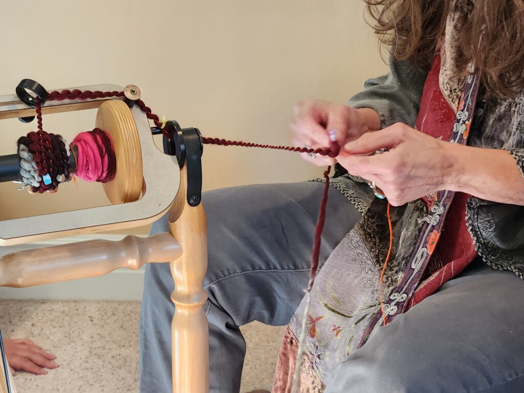 Spinner coiling wool over thread