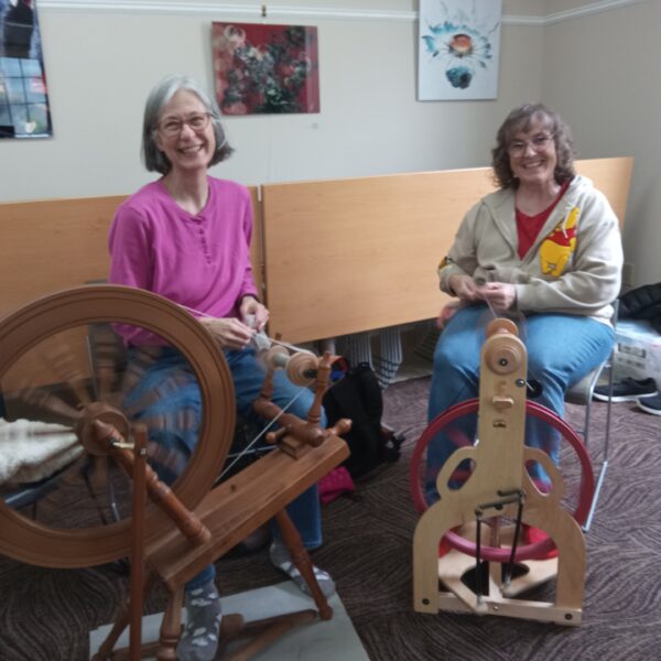 Two women at spinning hw\\wheels