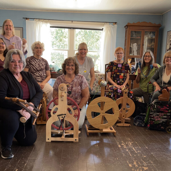 Ten guild members with spinning wheels