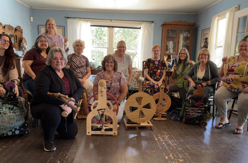 Ten guild members with spinning wheels