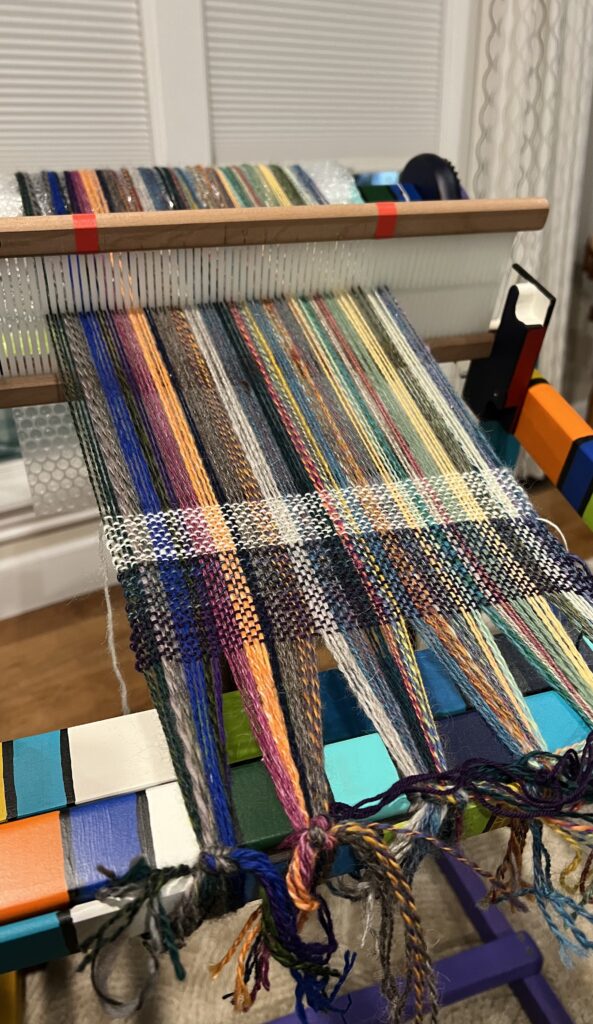 stripes of yarn on ridig heddle loom