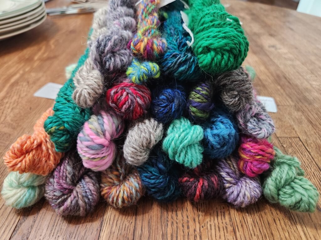 A pile of small handspun skeins
